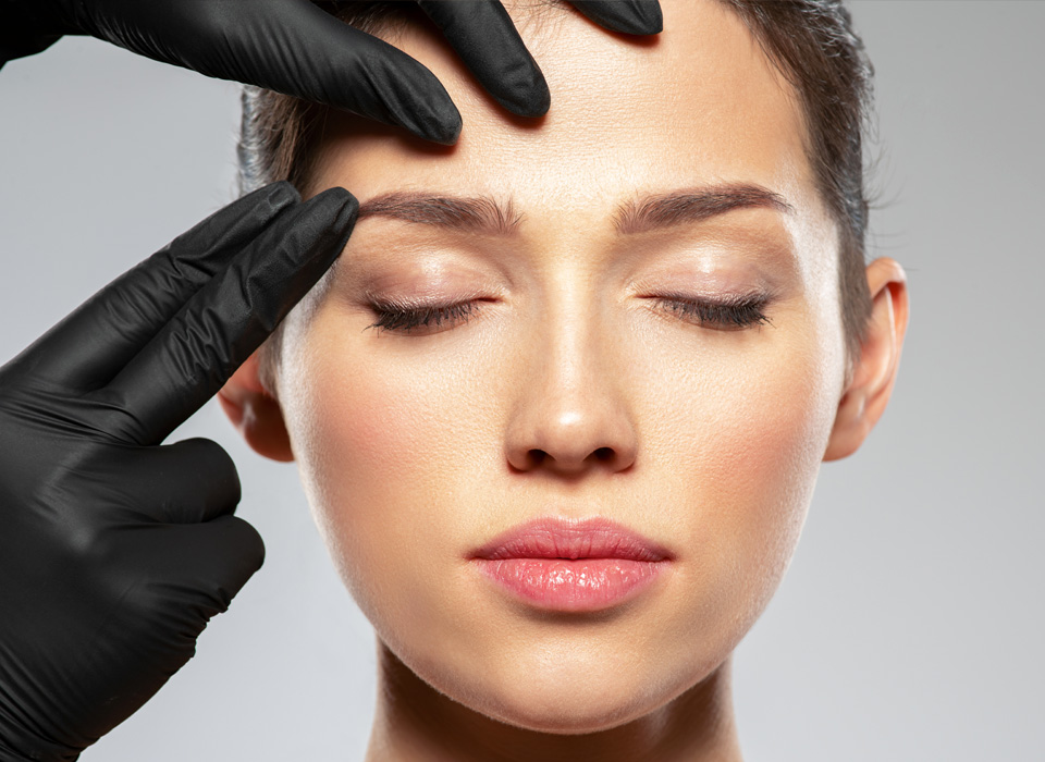 As asian girl is being checked her eye brow area with doctor's hands