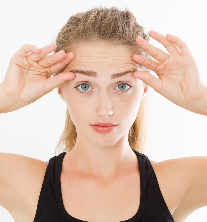 A girl holding her eyebrows with both hands