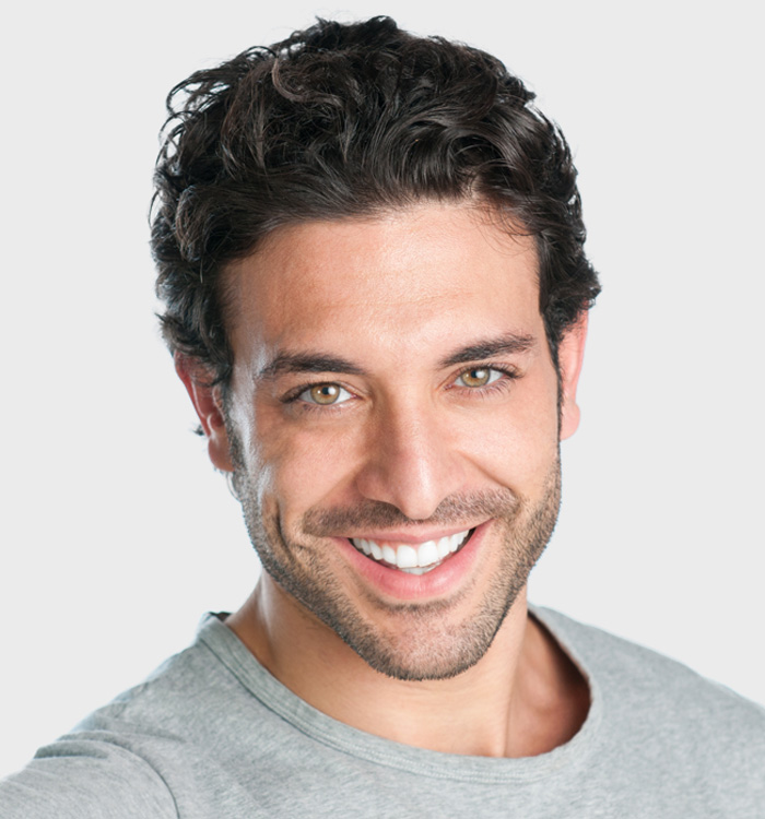 A smiling man with grey colored tshirt